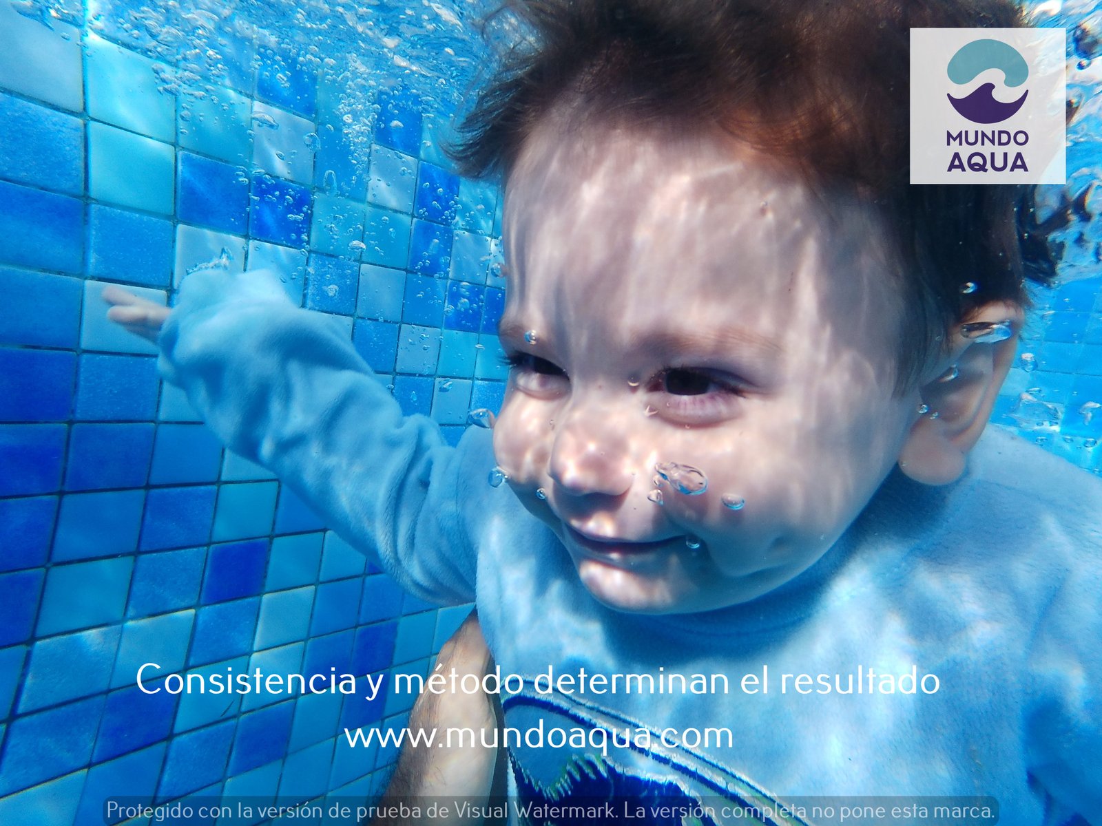 2-year-old girl swimming underwater in Merida Yucatan with heavy casual clothes